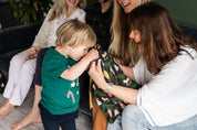 little boy looking into a Christmas Gift Bag made from cotton with gold ribbon