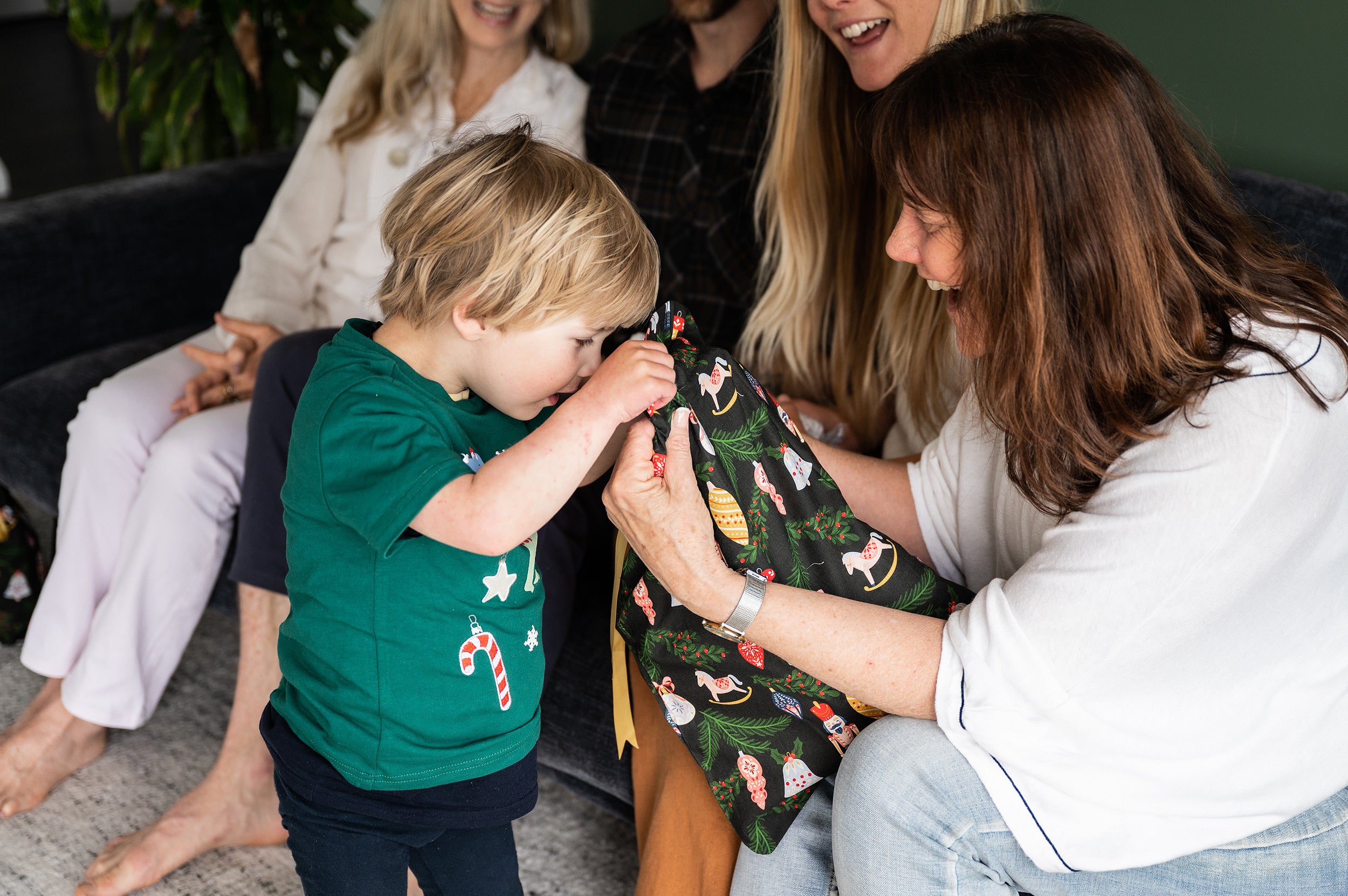 little boy looking into a Christmas Gift Bag made from cotton with gold ribbon