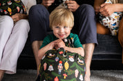 boy holding a reusable gift bag smiling
