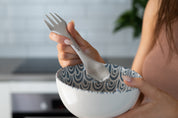 Stainless Spork from CaliWoods being used in a blue and white bowl