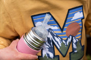Pura kiki water bottle held in a boy's hand, close up of the lid.