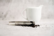 Tea Infuser lying on it's side with tea spilling out