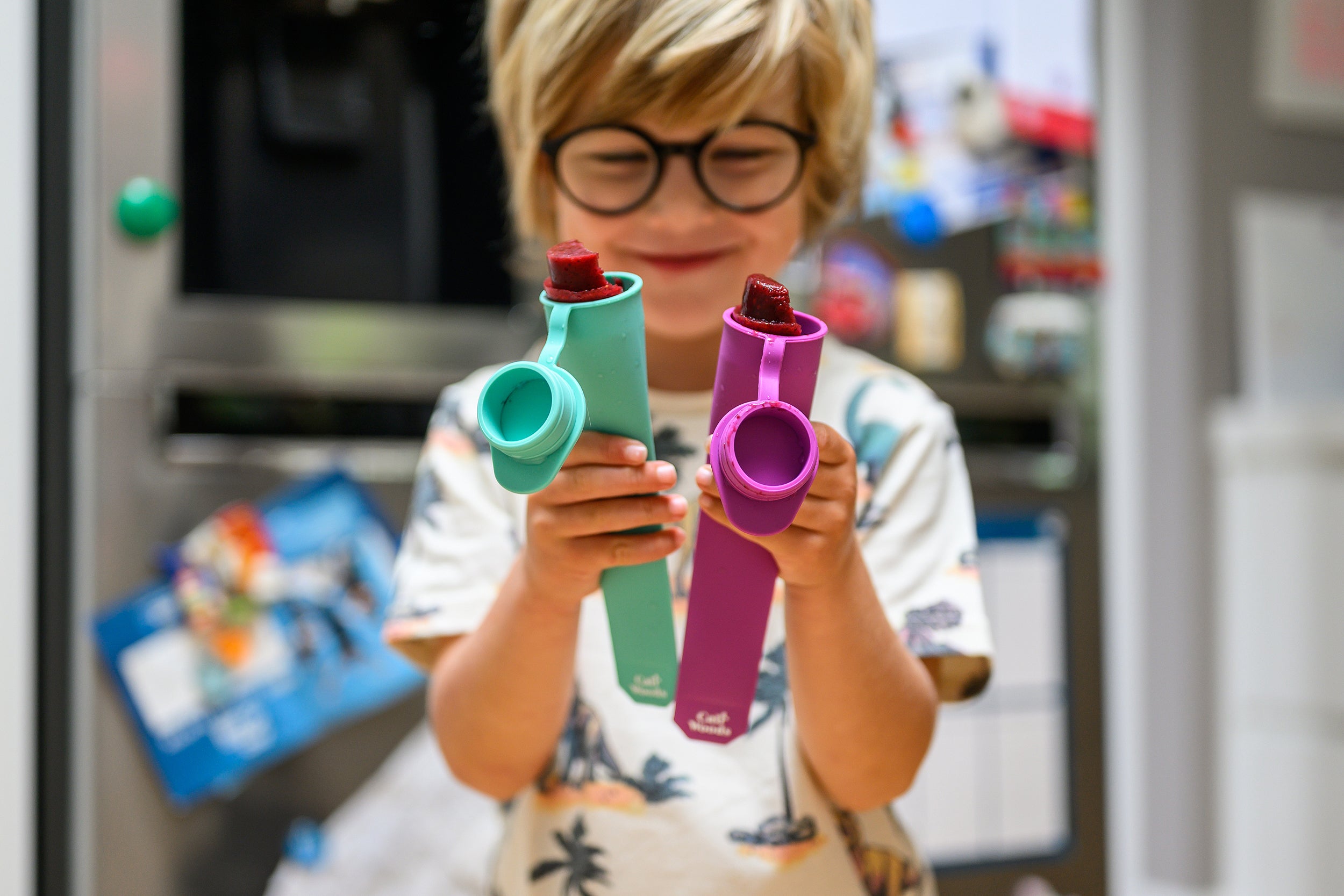 Boy holding reusable ice block moulds