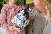 CaliWoods reusable gift bag with native birds on the fabric with boy and Mum in the background