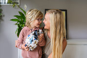 Mum and son smiling at each other while boy holds a CaliWoods reusable gift bag