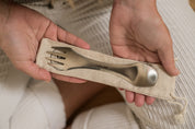 CaliWoods Stainless Spork held in hands of woman sitting cross legged