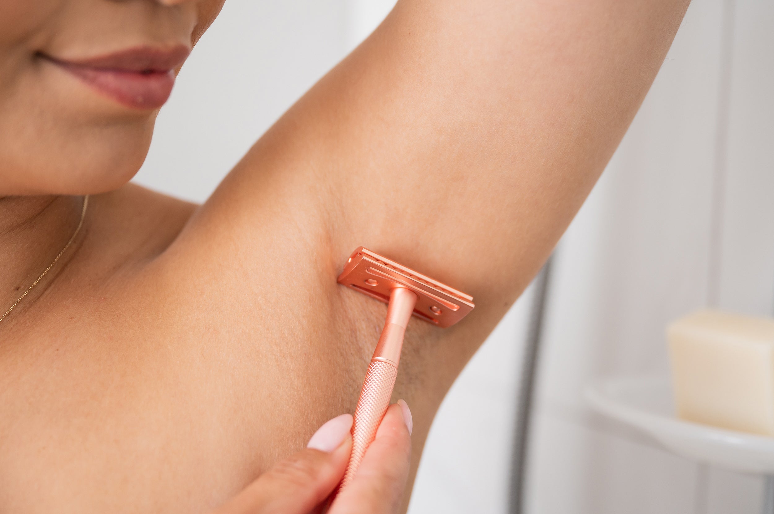 Close up on armpit being shaved with Copper CaliWoods Safety Razor