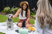 Two women having a picnic with 1.9L stainless cooler bottle