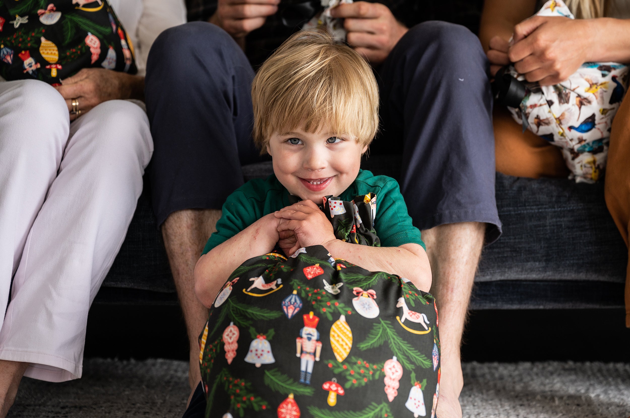 boy holding a reusable gift bag smiling 