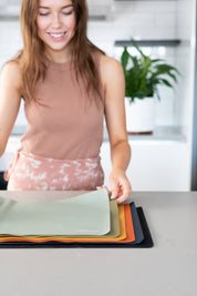 Baking Mats with woman holding them with her hands 