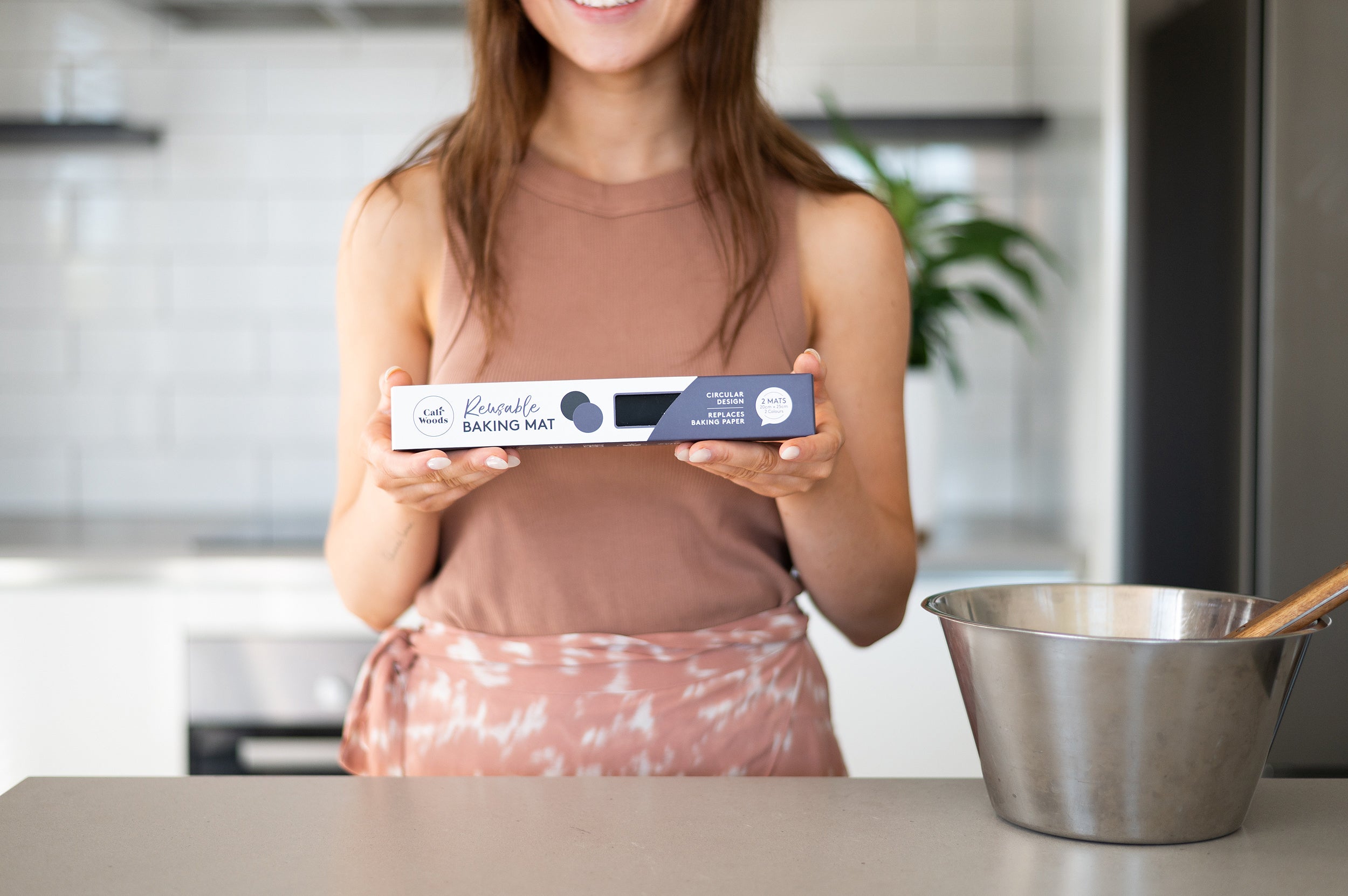 Woman holding circular baking mat pack 