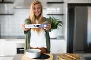 CaliWoods circular Baking Mats being held by a smiling woman