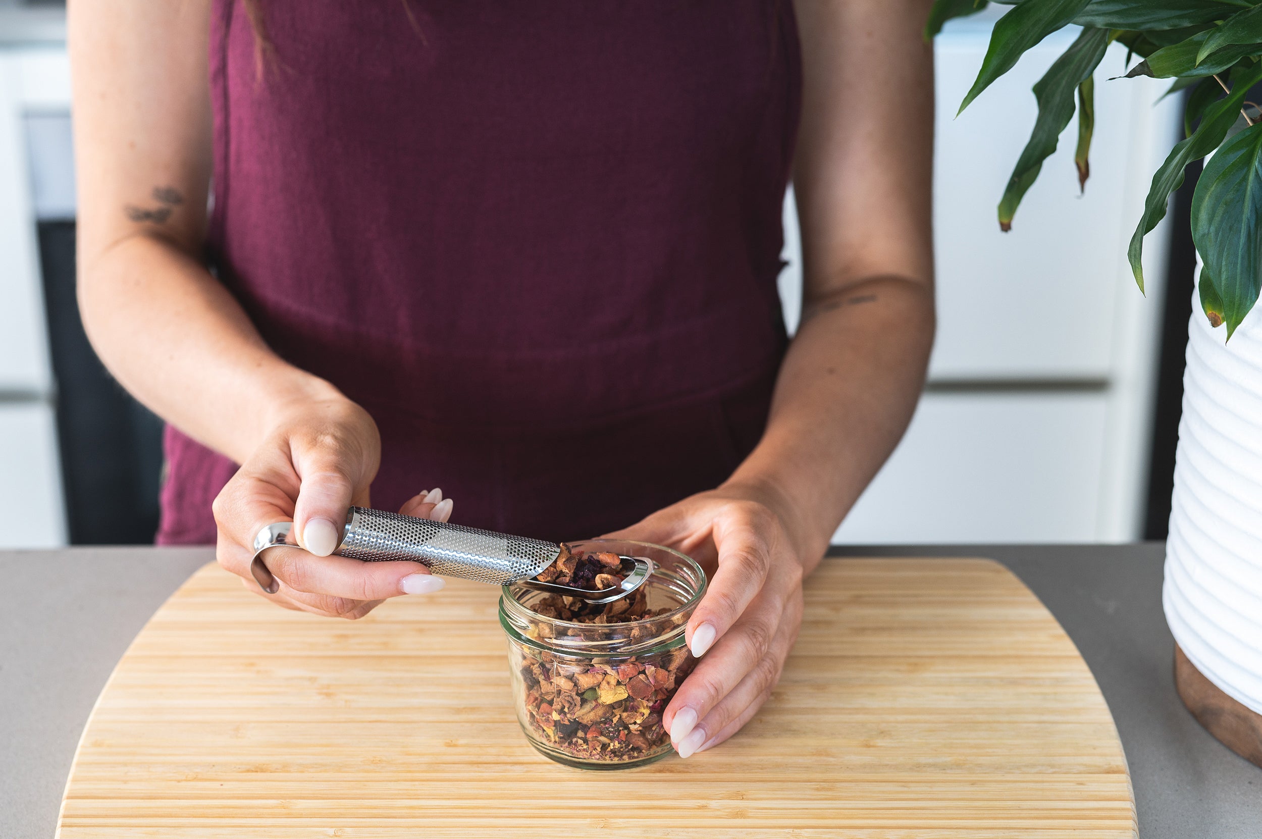 CaliWoods Stainless Steel Tea Infuser being filled with fruity loose leaf herbal tea 