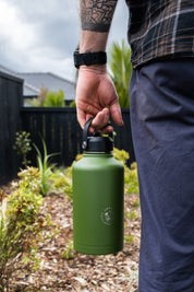 Large water cooler from CaliWoods held by man showing his hand, watch, and tattoo