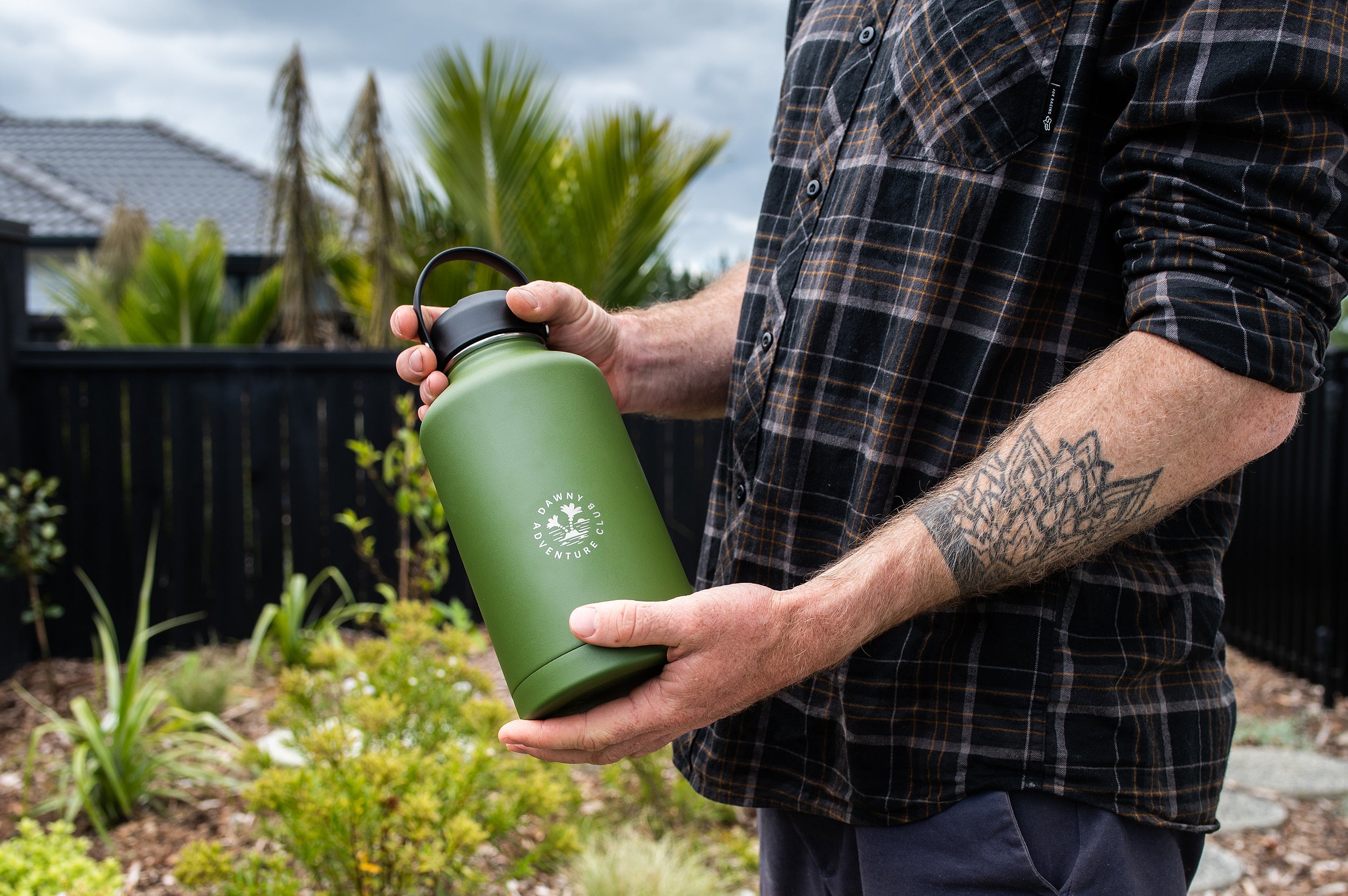 Man holding large insulated Dawny cooler in his hand showing swing lid