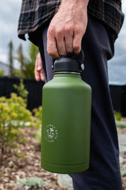 Man holding a large water cooler from CaliWoods down by his side