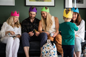 A family smile wearing caliwoods reusable party hats