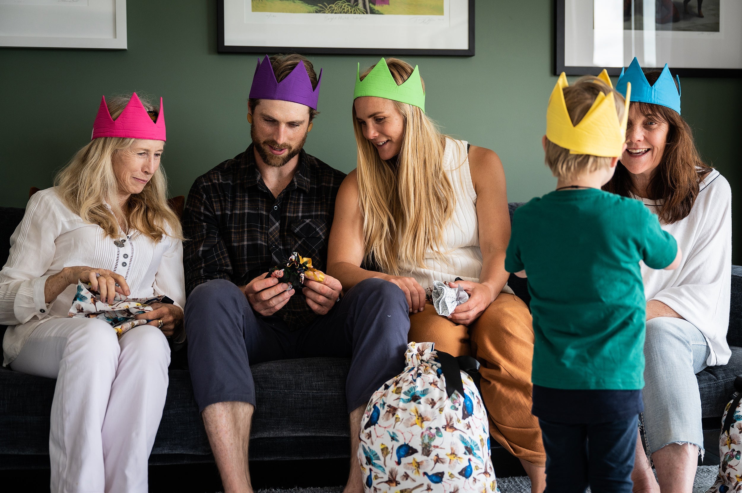 A family smile wearing caliwoods reusable party hats