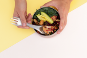 CaliWoods Spork being used for lunch, dipping into salad in a stainless container