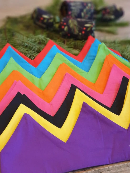 a stack of caliwoods reusable party hats in multiple colours